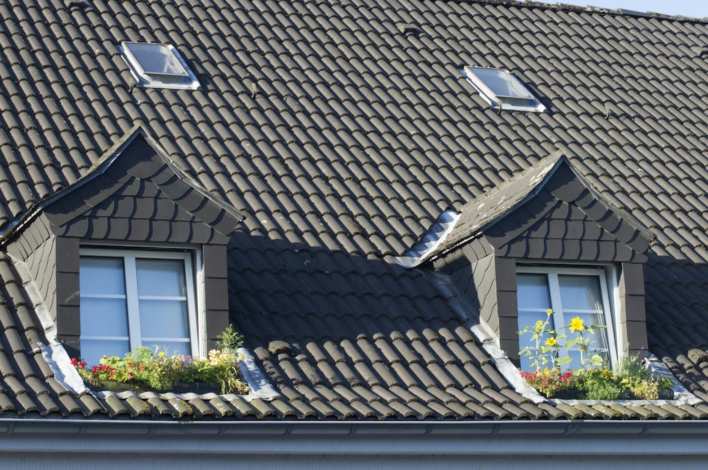 Dark tile roof with two dormers, skylights, and flower boxes in Alpine, NJ