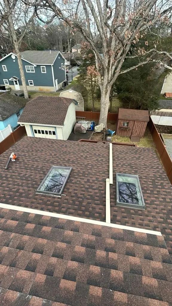Finished architectural shingle roof with two skylights